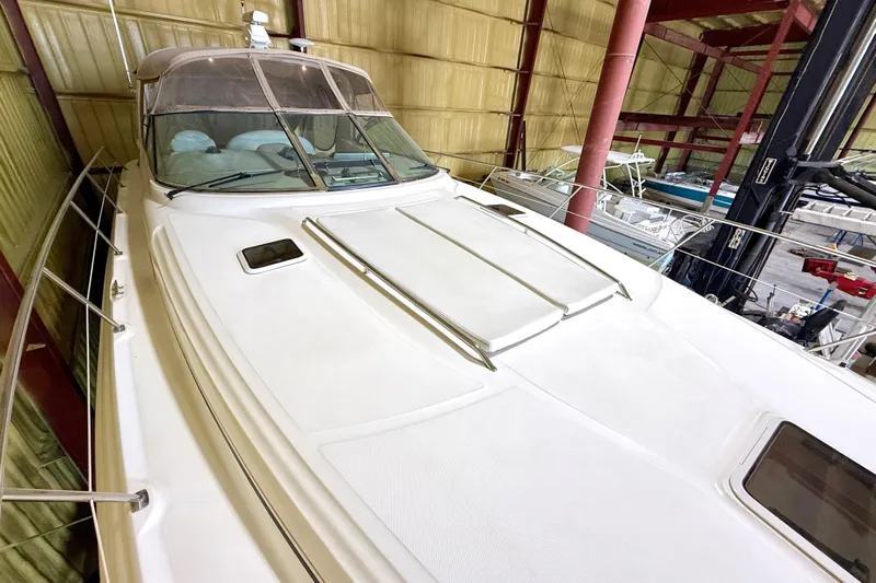 No Tan Lines Yacht Photos Pics 2000 Sea Ray 410 Sundancer yacht in storage, showcasing sleek design and spacious deck.