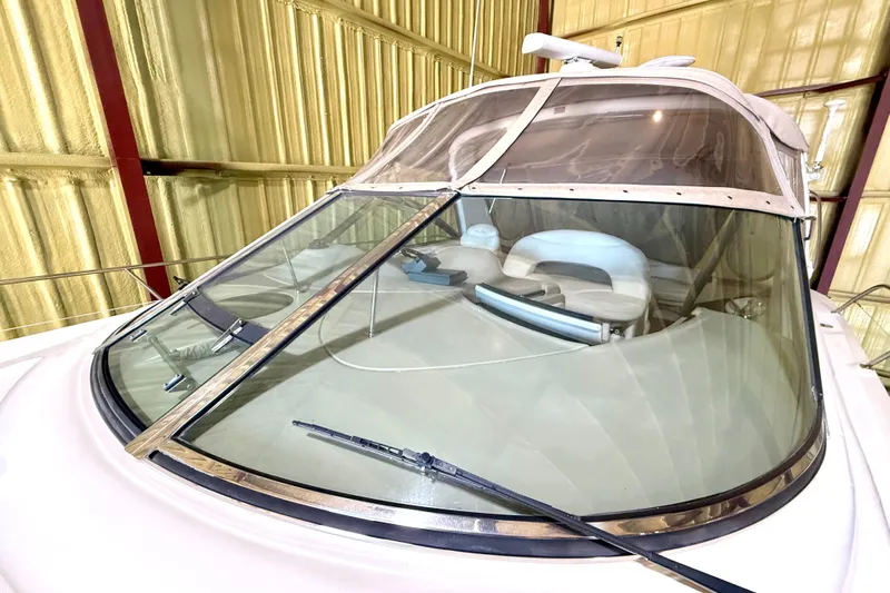 No Tan Lines Yacht Photos Pics 2000 Sea Ray 410 Sundancer yacht in storage, showcasing cockpit and windshield.