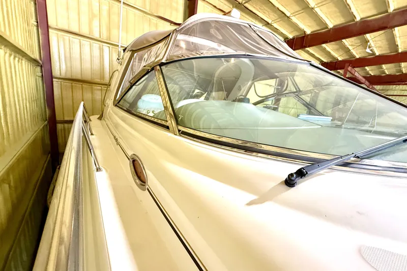 No Tan Lines Yacht Photos Pics 2000 Sea Ray 410 Sundancer yacht in storage, showcasing sleek design and windshield.