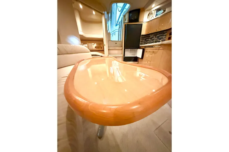 No Tan Lines Yacht Photos Pics Luxurious interior of 2000 Sea Ray 410 Sundancer yacht with polished wooden table.