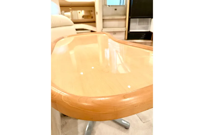 No Tan Lines Yacht Photos Pics Polished wooden table inside 2000 Sea Ray 410 Sundancer yacht cabin.