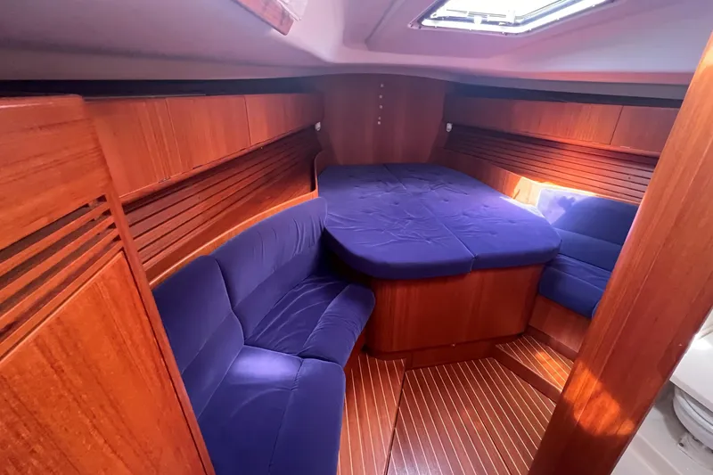 St. Francis Yacht Photos Pics Luxurious cabin interior of 2001 X-Yachts 482 Modern with blue upholstery and wood finish.