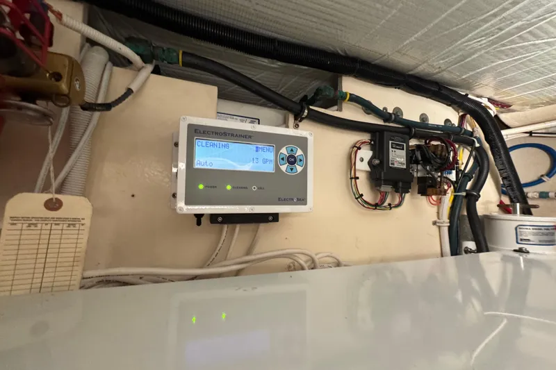  Yacht Photos Pics Control panel in 2016 Tiara Yachts C44 Coupe engine room, displaying cleaning status.