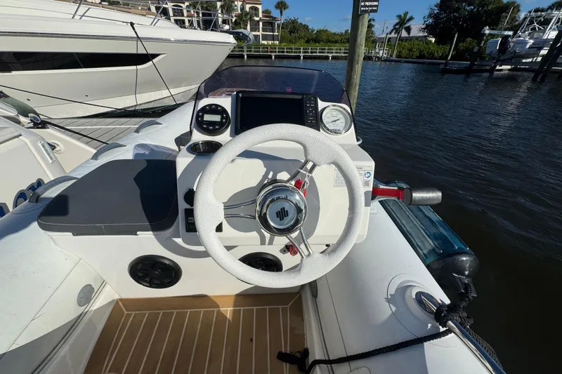  Yacht Photos Pics Helm of 2016 Tiara Yachts C44 Coupe with white steering wheel and navigation instruments.