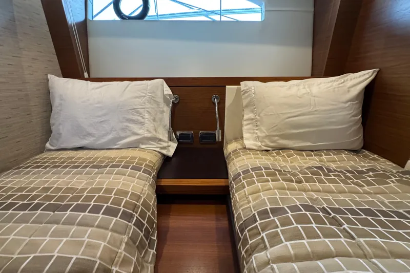  Yacht Photos Pics Cabin interior of 2016 Tiara Yachts C44 Coupe with twin beds and modern decor.