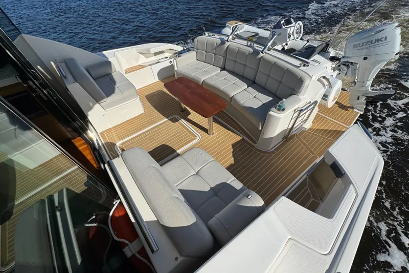  Yacht Photos Pics 2016 Tiara Yachts C44 Coupe with spacious deck, luxurious seating, and Suzuki outboard engine.