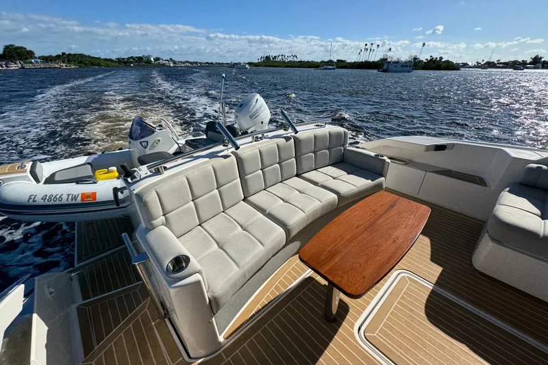  Yacht Photos Pics 2016 Tiara Yachts C44 Coupe with spacious seating and wooden table on open water.