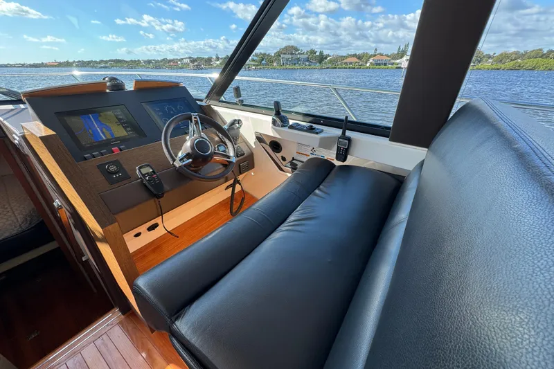  Yacht Photos Pics 2016 Tiara Yachts C44 Coupe helm with leather seating and navigation display.