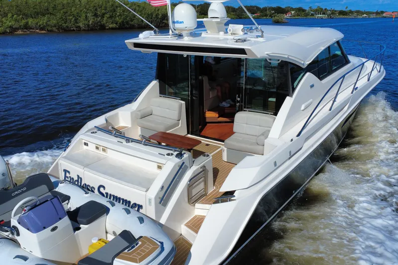  Yacht Photos Pics 2016 Tiara Yachts C44 Coupe cruising on a scenic waterway.