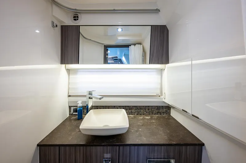  Yacht Photos Pics Modern bathroom interior on 2020 Sea Ray SLX 400 yacht, featuring sleek sink and mirror.