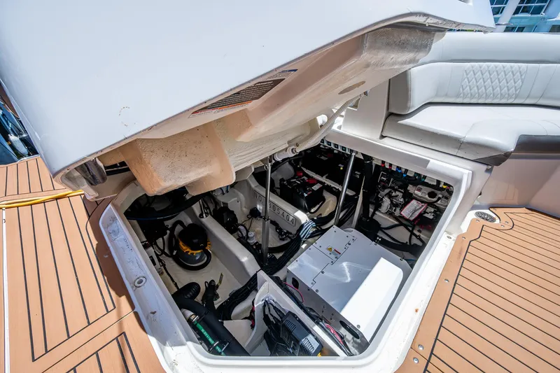  Yacht Photos Pics Engine compartment of 2020 Sea Ray SLX 400 boat, showcasing mechanical components and seating area.