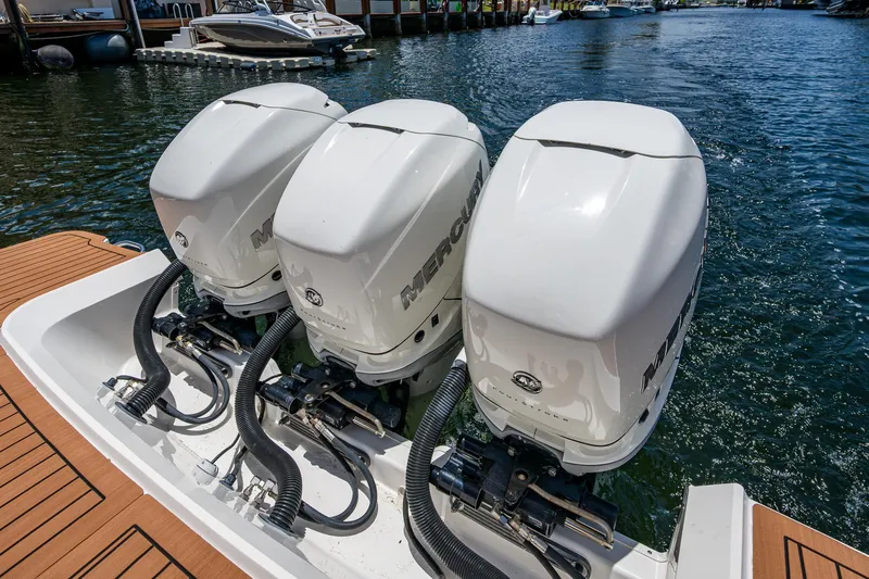  Yacht Photos Pics Triple Mercury outboard engines on a 2020 Sea Ray SLX 400 boat, docked by the water.
