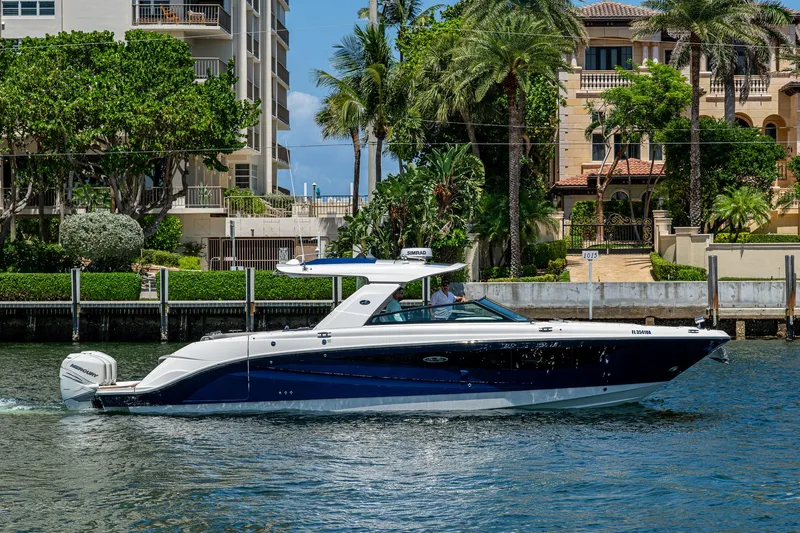  Yacht Photos Pics 2020 Sea Ray SLX 400 boat cruising near waterfront homes with lush greenery.