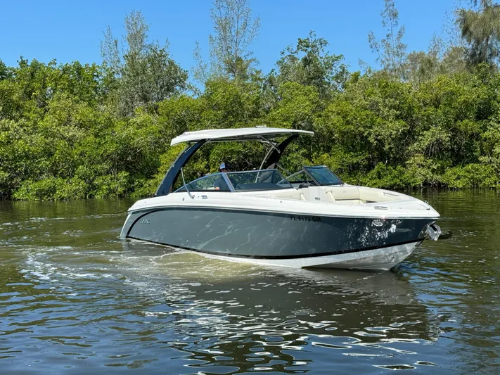  Yacht Photos Pics 2020 Cobalt R30 boat cruising on a calm river with lush greenery.