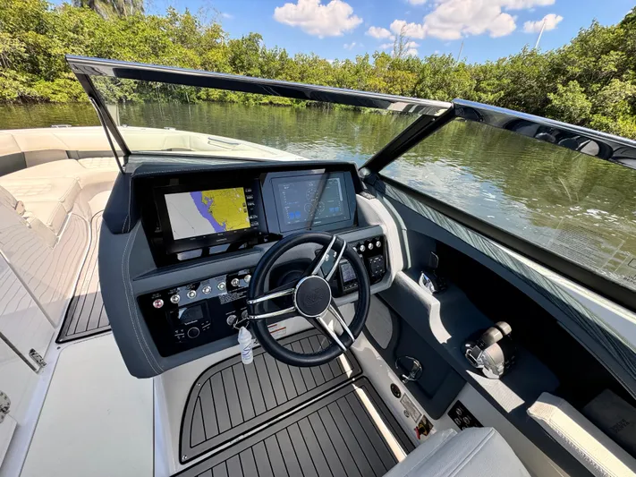  Yacht Photos Pics 2020 Cobalt R30 boat dashboard with navigation screens on a calm river.