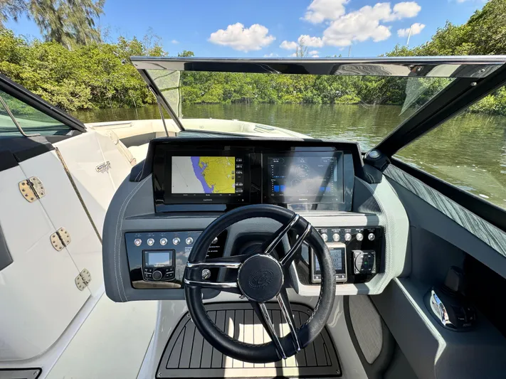  Yacht Photos Pics 2020 Cobalt R30 boat dashboard with navigation screens and steering wheel.