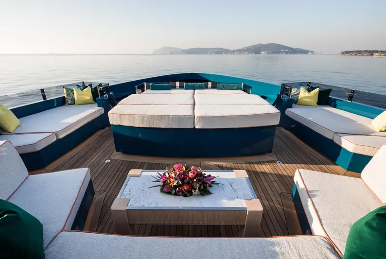 King Benji Yacht Photos Pics Luxurious 2024 Dunya Yachts deck with elegant seating and scenic ocean view.