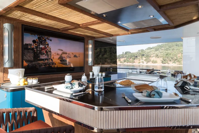 King Benji Yacht Photos Pics Luxurious interior of 2024 Dunya Yacht with elegant dining setup and scenic view.