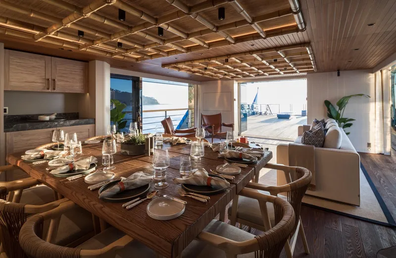 King Benji Yacht Photos Pics Luxurious dining area on 2024 Dunya Yachts, featuring elegant table setting and ocean view.