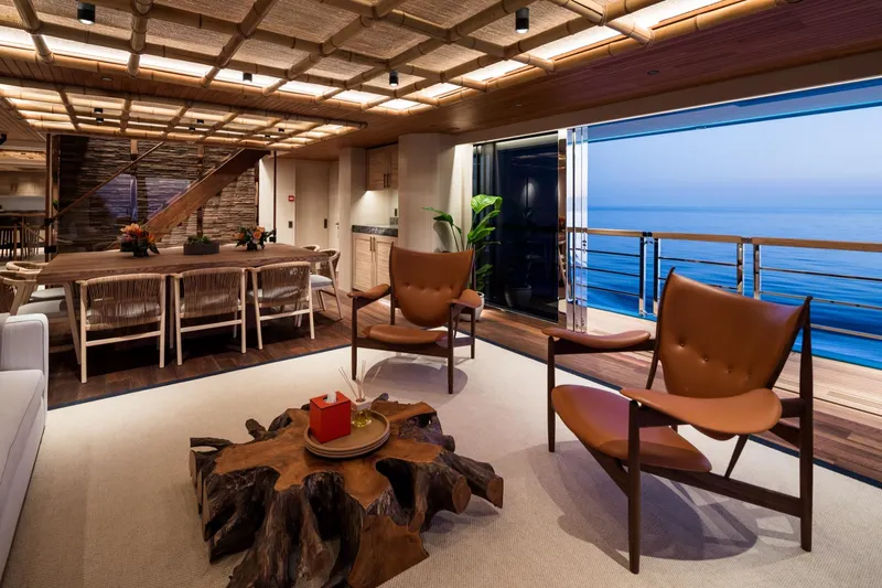 King Benji Yacht Photos Pics Luxurious interior of 2024 Dunya Yachts with ocean view, elegant seating, and wooden decor.