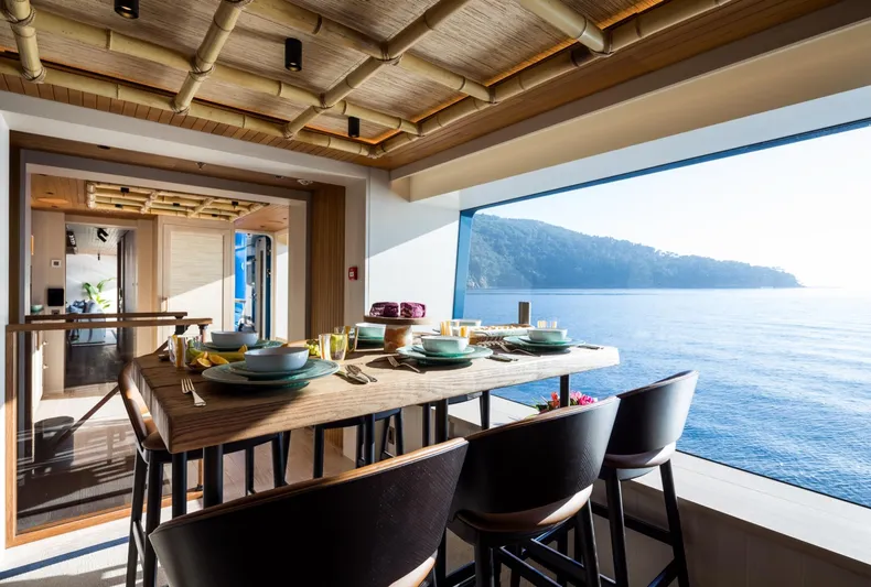 King Benji Yacht Photos Pics Luxurious dining area on 2024 Dunya Yacht with ocean view and elegant table setting.