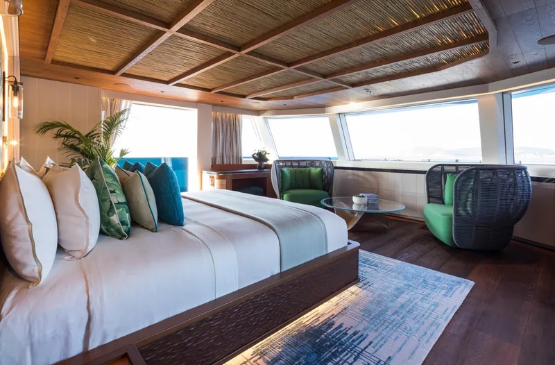 King Benji Yacht Photos Pics Luxurious 2024 Dunya Yachts bedroom with modern decor and panoramic windows.