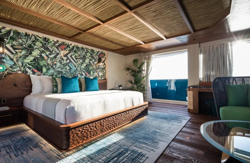 King Benji Yacht Photos Pics Luxurious bedroom on 2024 Dunya Yacht with tropical decor and ocean view.