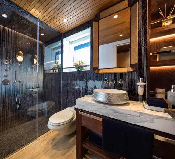 King Benji Yacht Photos Pics Luxurious 2024 Dunya Yachts bathroom with modern fixtures, marble sink, and elegant shower design.