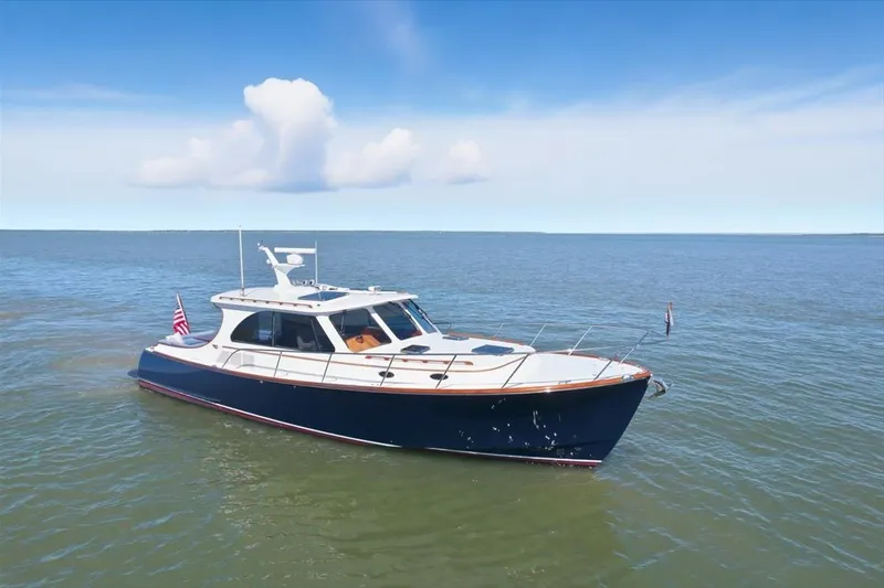 Jeannius II Yacht Photos Pics 2015 Hinckley Talaria 43 yacht cruising on open water under a clear blue sky.