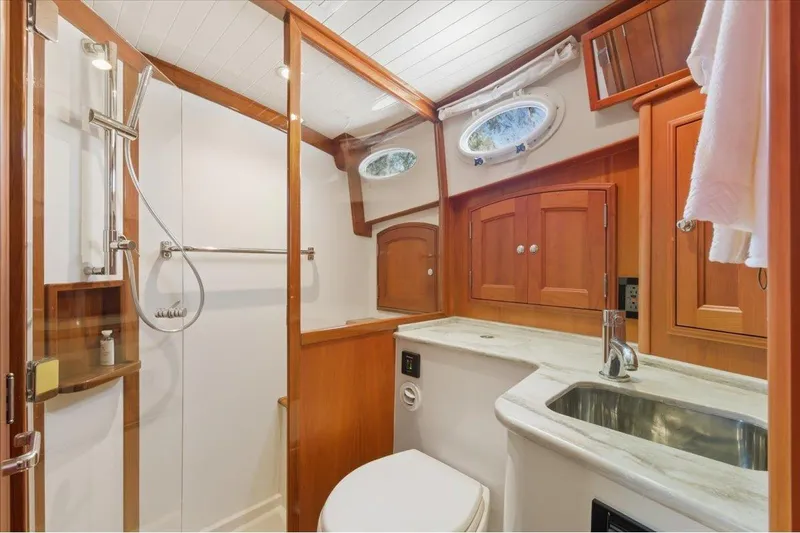 Jeannius II Yacht Photos Pics Luxurious 2015 Hinckley Talaria 43 yacht bathroom with wood accents and modern fixtures.