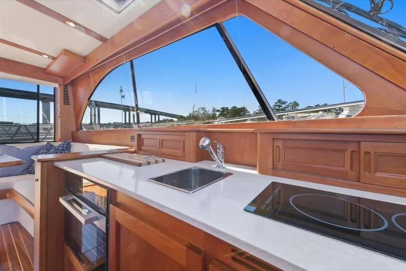 Jeannius II Yacht Photos Pics Interior of 2015 Hinckley Talaria 43 yacht with modern kitchen and panoramic windows.