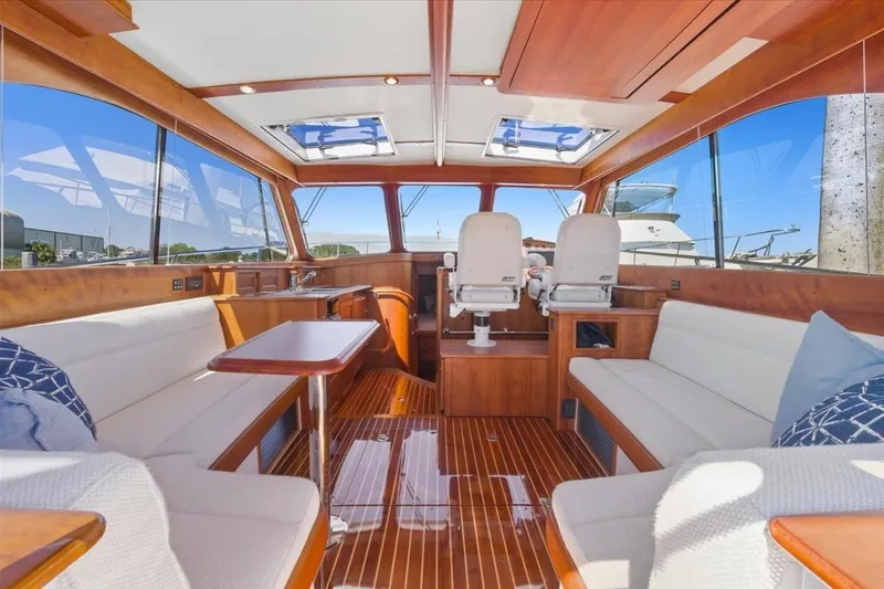 Jeannius II Yacht Photos Pics Luxurious interior of 2015 Hinckley Talaria 43 yacht with elegant wood finish and plush seating.