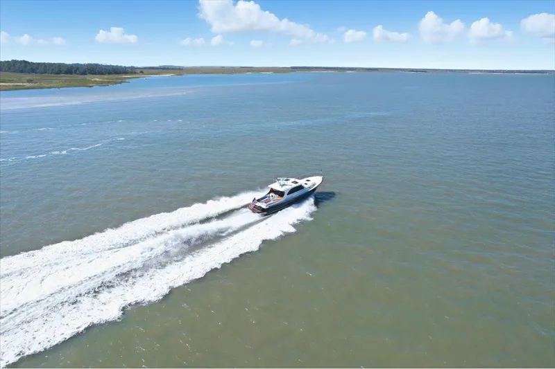 Jeannius II Yacht Photos Pics 2015 Hinckley Talaria 43 cruising on open water under a clear blue sky.