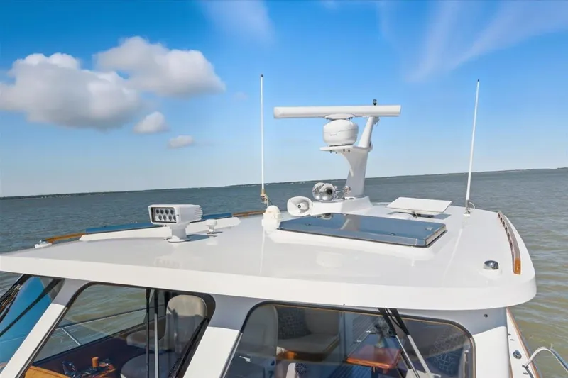 Jeannius II Yacht Photos Pics 2015 Hinckley Talaria 43 yacht roof with radar, cruising on open water.