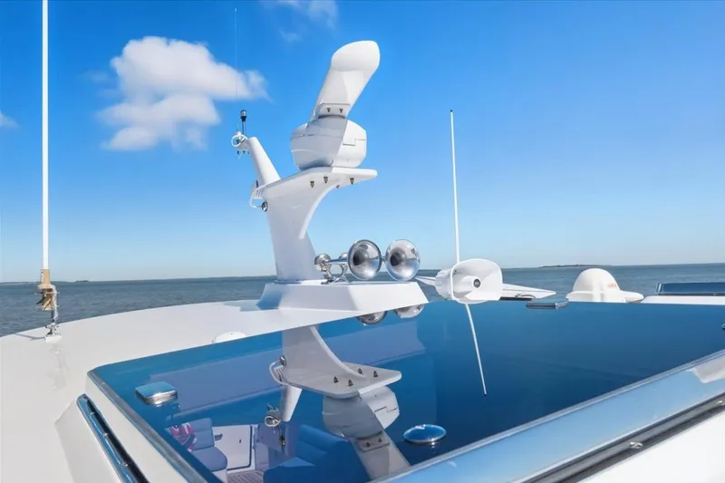 Jeannius II Yacht Photos Pics 2015 Hinckley Talaria 43 yacht with radar equipment against a clear blue sky.