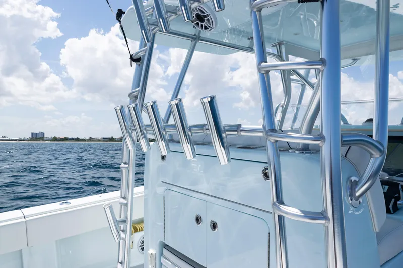  Yacht Photos Pics 2023 SeaVee 390Z boat with rod holders and ladder, ocean backdrop.