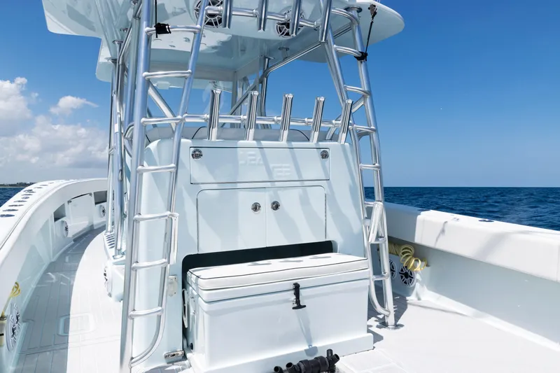  Yacht Photos Pics 2023 SeaVee 390Z boat interior with rod holders, ocean view, and clear blue sky.