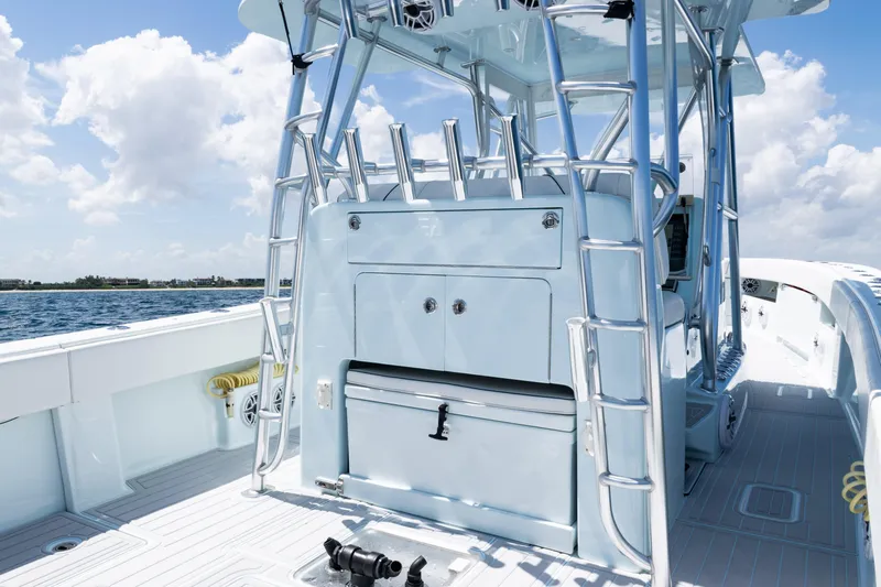 Yacht Photos Pics 2023 SeaVee 390Z boat deck with storage and rod holders, under a clear sky.