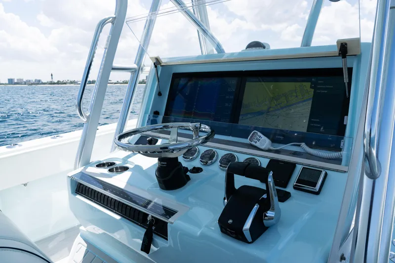  Yacht Photos Pics 2023 SeaVee 390Z boat dashboard with navigation screens and controls, overlooking the ocean.