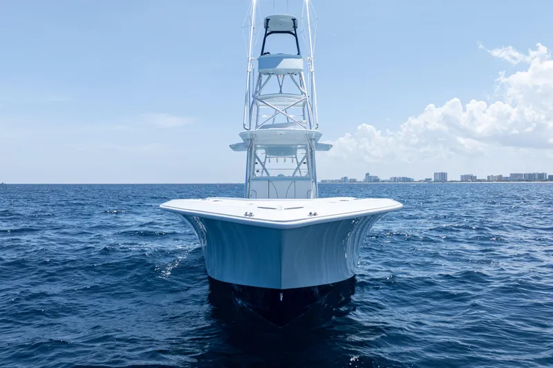  Yacht Photos Pics 2023 SeaVee 390Z boat on open ocean with clear sky and distant cityscape.