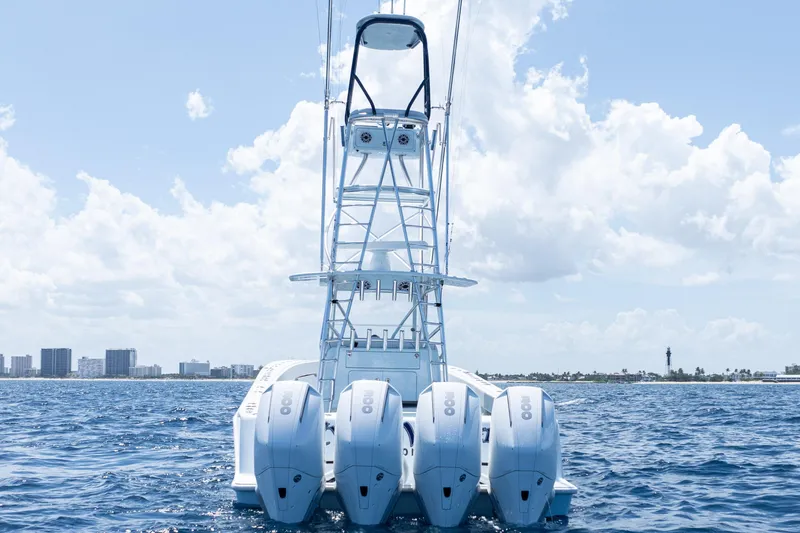  Yacht Photos Pics 2023 SeaVee 390Z boat with four engines on open water, city skyline in background.