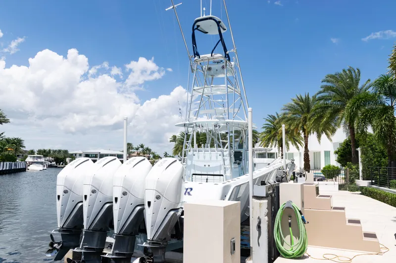  Yacht Photos Pics 2023 SeaVee 390Z boat docked with four outboard engines, surrounded by palm trees.