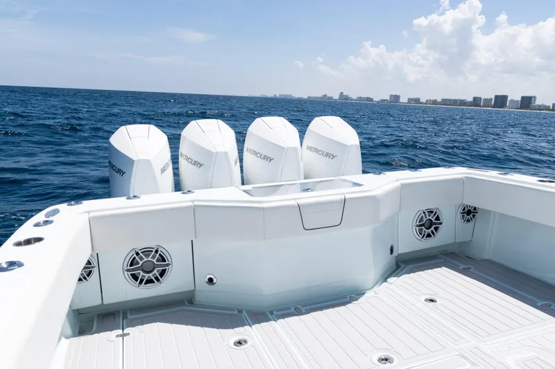  Yacht Photos Pics 2023 SeaVee 390Z boat with Mercury engines, ocean view, and city skyline in the background.