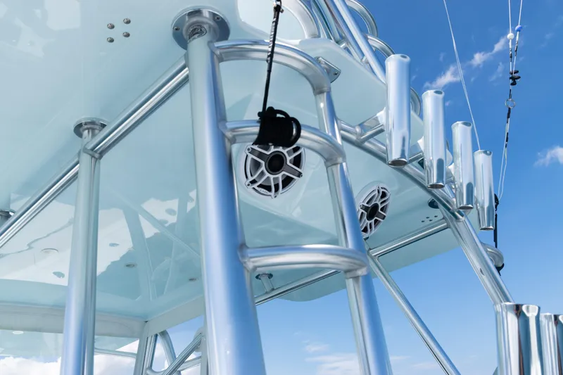  Yacht Photos Pics 2023 SeaVee 390Z boat tower with rod holders and speakers against blue sky.
