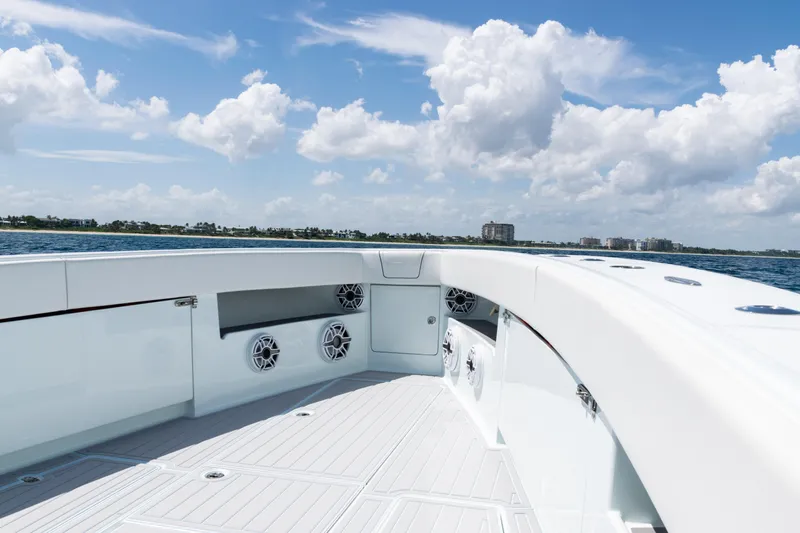  Yacht Photos Pics 2023 SeaVee 390Z boat deck with speakers, ocean view, and blue sky.