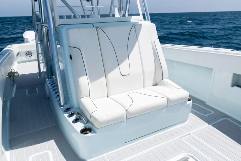  Yacht Photos Pics 2023 SeaVee 390Z boat with white seating, ocean backdrop, and sleek design.