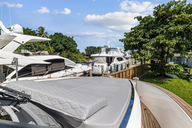  Yacht Photos Pics 2023 Astondoa 377 Coupe Outboard yacht docked in a marina with other boats.