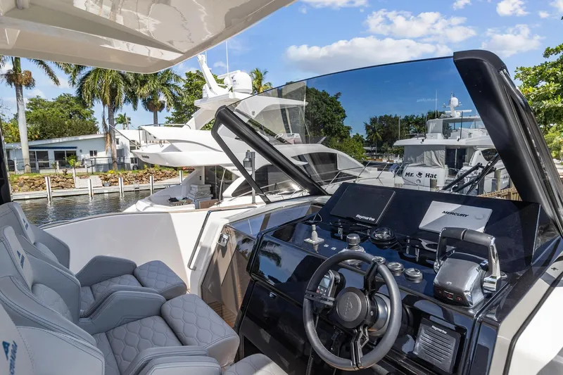  Yacht Photos Pics 2023 Astondoa 377 Coupe Outboard helm station with luxurious seating and modern controls.