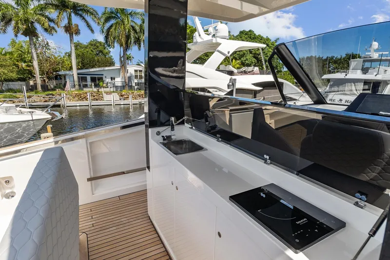  Yacht Photos Pics 2023 Astondoa 377 Coupe Outboard yacht interior with modern kitchen and waterfront view.