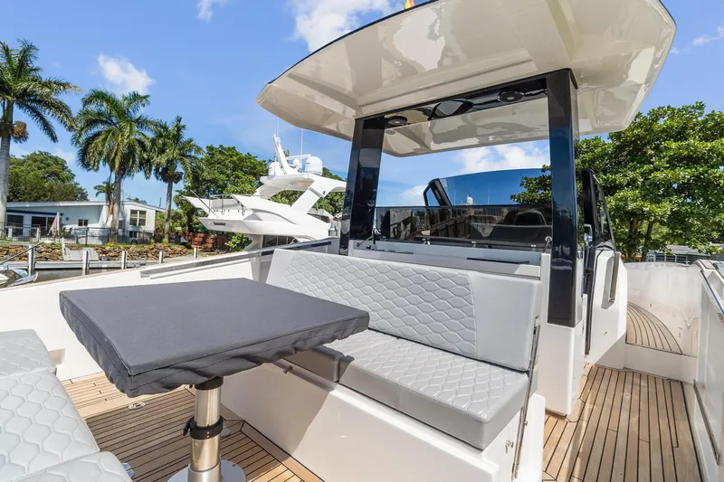  Yacht Photos Pics 2023 Astondoa 377 Coupe Outboard yacht deck with seating and table.